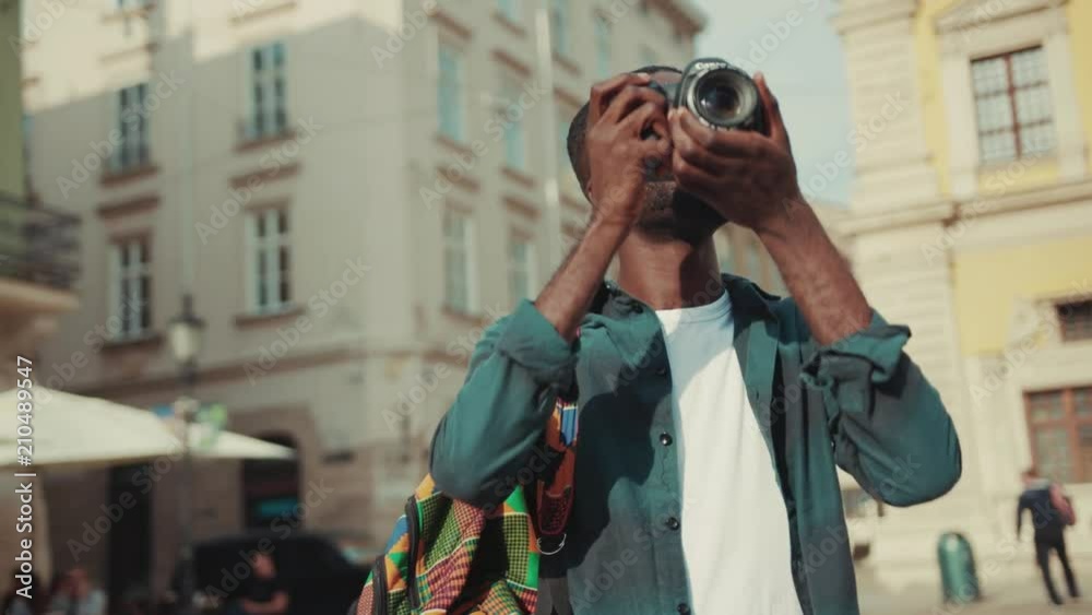 African american young man happy tourist taking photo on his camera travelling in Europe face technology handsome street urban black portrait afro close up individuality mobile phone photography