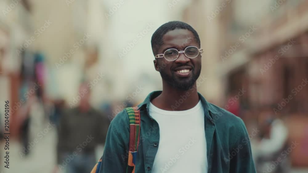 Portrait young African American with glasses look at camera smile feel happy standing in city face outdoor cheerful adult business fashion corporate party man successful internet handsome technology Portrait young African American with glasses look at camera smile feel happy standing in city face outdoor cheerful adult business fashion corporate party man successful internet handsome technology