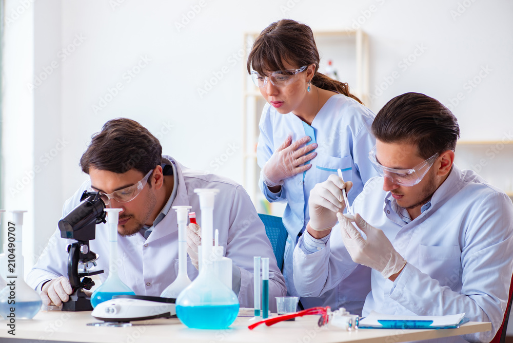 Team of chemists working in the lab Team of chemists working in the lab