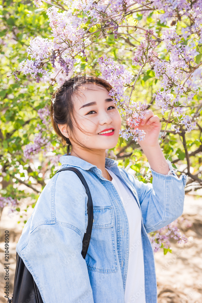 Outdoor portrait of beautiful happy young woman enjoying spring flower Outdoor portrait of beautiful happy young woman enjoying spring flower