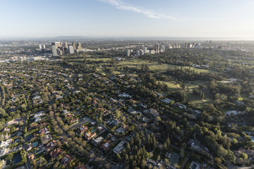 Aerial view of Beverly Hills residential streets with Century City and Westwood skylines in background in Los Angeles California.