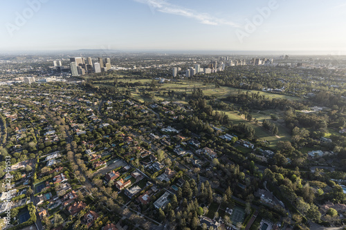 Aerial view of Beverly Hills residential streets with Century City and Westwood skylines in background in Los Angeles California.