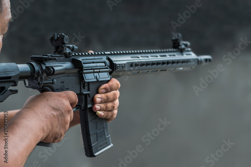 Man holding gun aiming pistol in shooting range