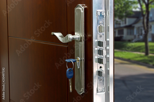 Open door of a family home. Close-up of the lock with your keys on an armored door. Security.