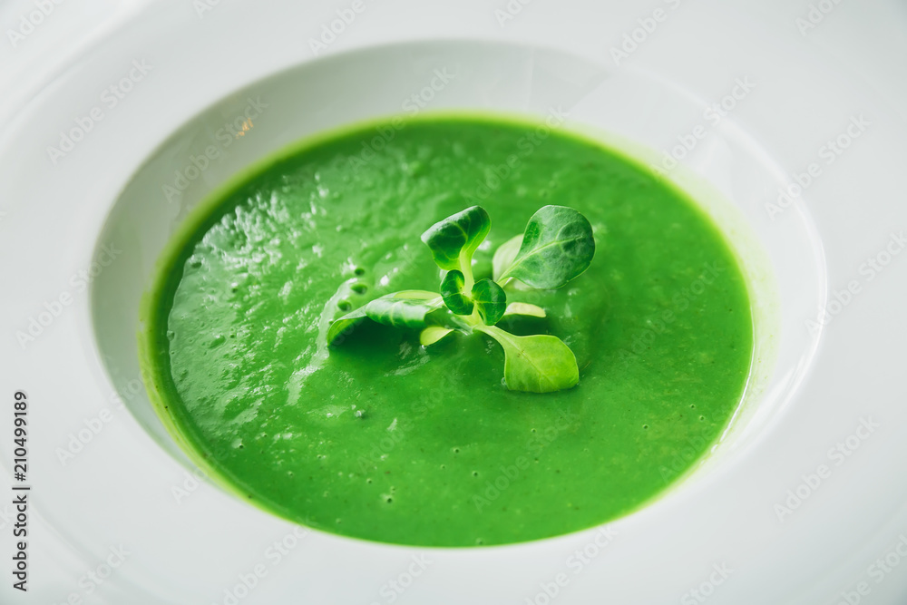 Homemade spinach soup in a bowl on gray background. Green vegetarian soup. Flat lay. Top view Homemade spinach soup in a bowl on gray background. Green vegetarian soup. Flat lay. Top view