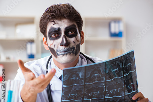 Scary monster doctor working in lab photo