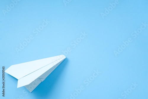 Blue paper plane on a colorful backgroun