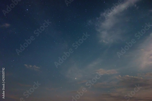 Night sky view with shining stars and the clouds