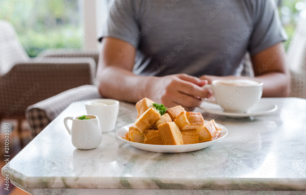 Toast is turned into small pieces and Thai tea with ice cream. and dripping sauce on top Toast is turned into small pieces and Thai tea with ice cream. and dripping sauce on top