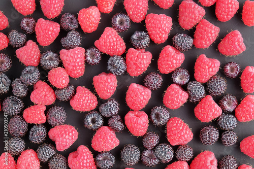 Ripe and black natural raspberries as background. Top view.