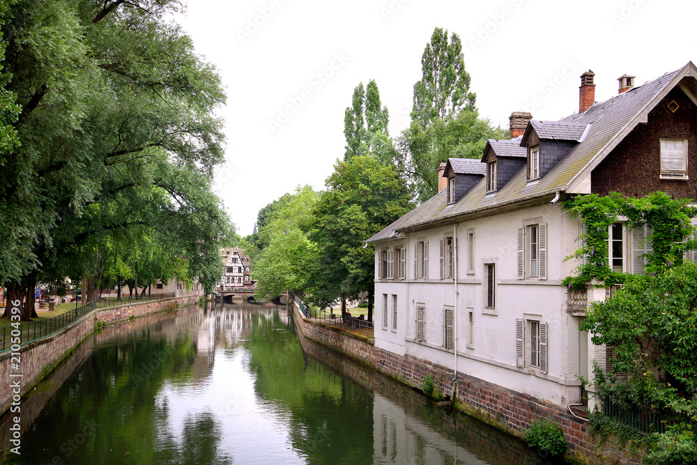 Beautiful view of historic French town with traditional houses and a river in summer. Strasbourg, France.