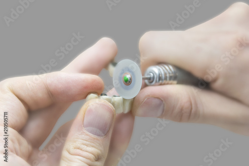 Medical dental technician working on prosthetic in laboratory
