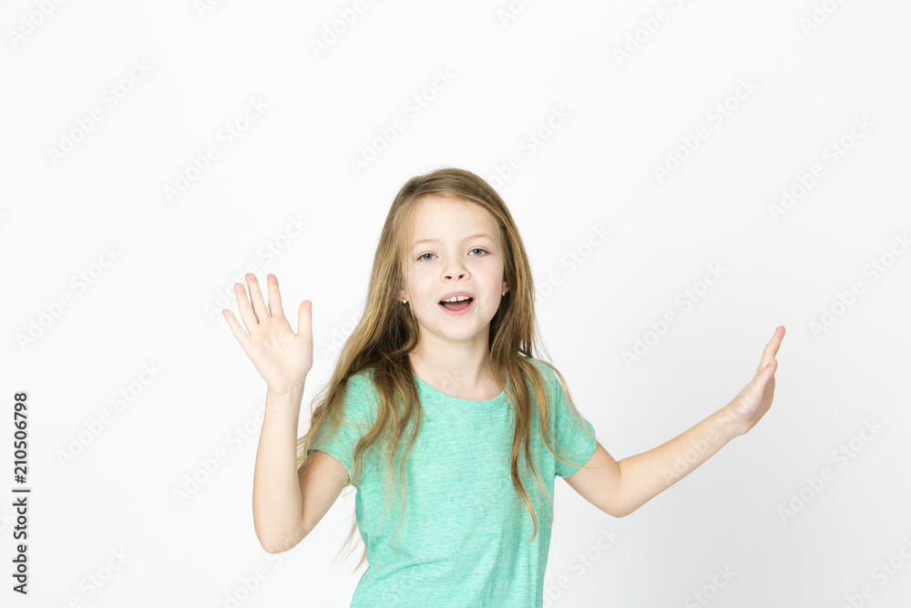 beautiful young girl is happy and dancing and posing in the studio in front of white background beautiful young girl is happy and dancing and posing in the studio in front of white background