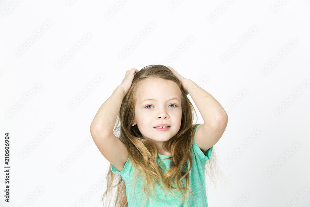 beautiful young girl is happy and dancing and posing in the studio in front of white background beautiful young girl is happy and dancing and posing in the studio in front of white background