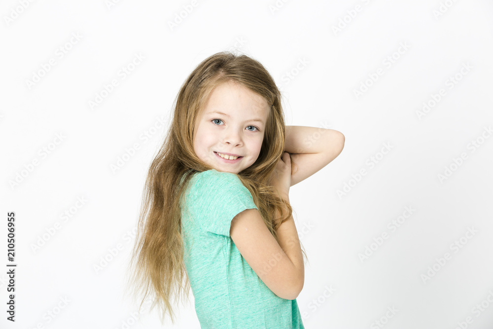 beautiful young girl is happy and dancing and posing in the studio in front of white background beautiful young girl is happy and dancing and posing in the studio in front of white background