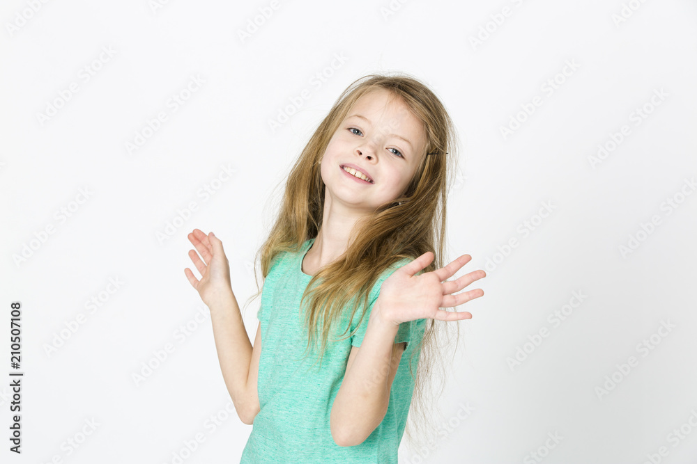 beautiful young girl is happy and dancing and posing in the studio in front of white background beautiful young girl is happy and dancing and posing in the studio in front of white background