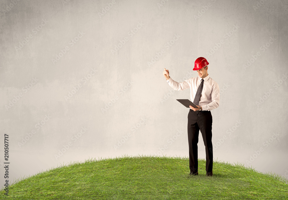 A successful caucasian elegant business man standing in small green grass with briefcase in front of clear empty background concept. A successful caucasian elegant business man standing in small green grass with briefcase in front of clear empty background concept.