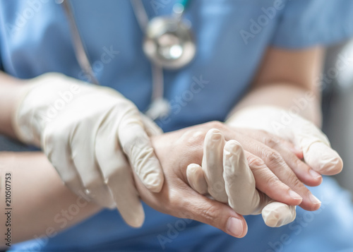 Surgeon, surgical doctor, anesthetist or anesthesiologist holding patient's hand for health care trust and support in professional surgical operation, medical anesthetic safety, ER healthcare concept photo