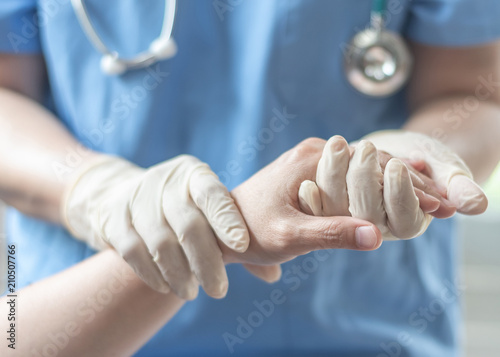 Surgeon, surgical doctor, anesthetist or anesthesiologist holding patient's hand for health care trust and support in professional surgical operation, medical anesthetic safety, ER healthcare concept photo