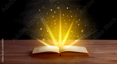Yellow lights and sparkles coming from an open book 