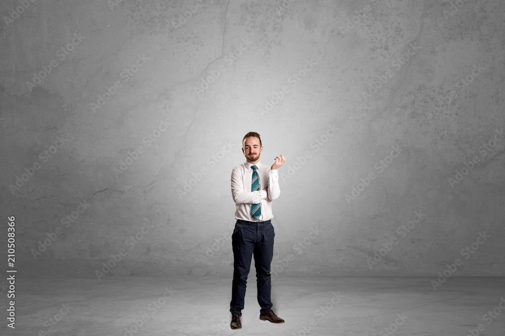 Alone handsome businessman standing in a dark empty room Alone handsome businessman standing in a dark empty room