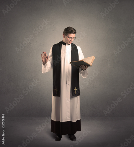 Obraz na plátně young priest in giving his blessing