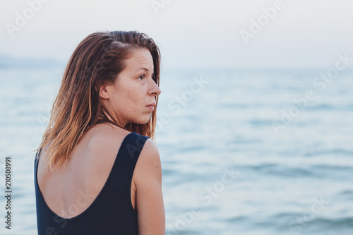 Woman alone and depressed sitting at the beach © marjan4782
