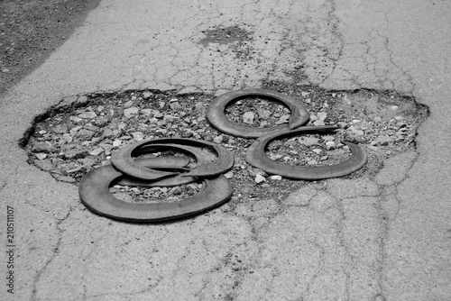 Broken car tires is on asphalt, black and white photo