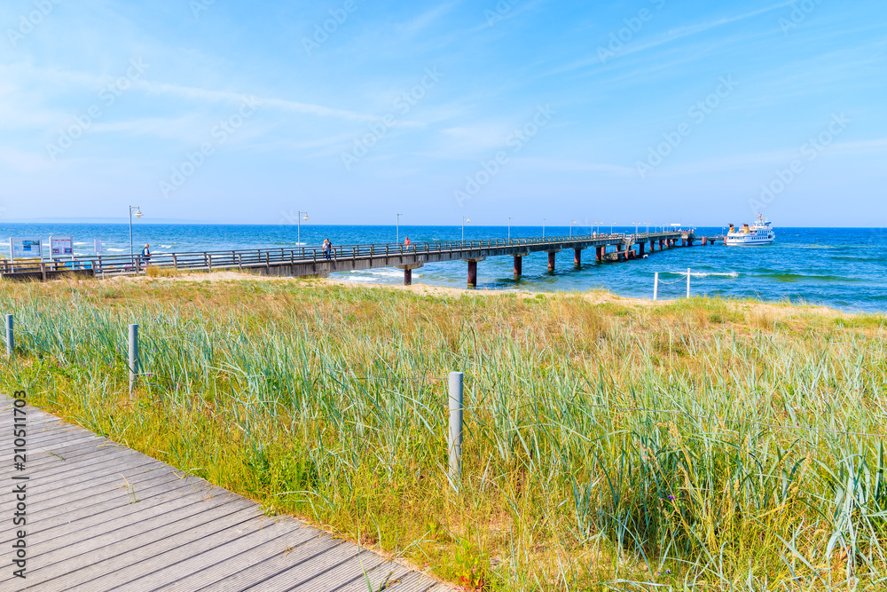Pier in Goehren summer resort, view from sand dune, Ruegen island, Baltic Sea, Germany