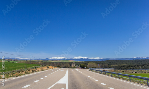 Highway leading to a snowcapped mountain range near Castilnovo, Spain