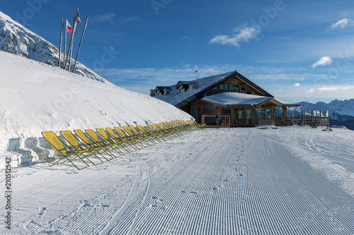 Dolomites, ski area with beautiful slopes. Empty ski slope in winter on a sunny day. Prepared piste and sunny day photo