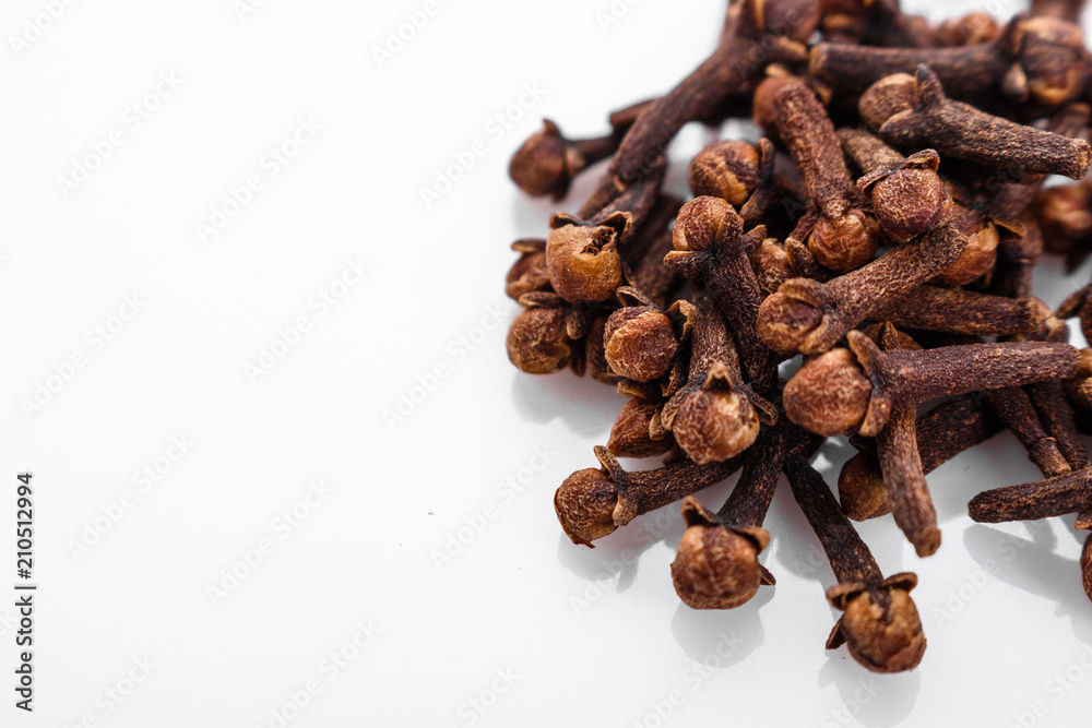 fragrant cloves on a white acrylic background fragrant cloves on a white acrylic background