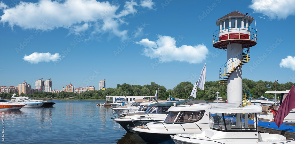 Kiev, Ukraine - June 01, 2018 : Yachts docked in city port. river parking of modern motor boats and blue river.