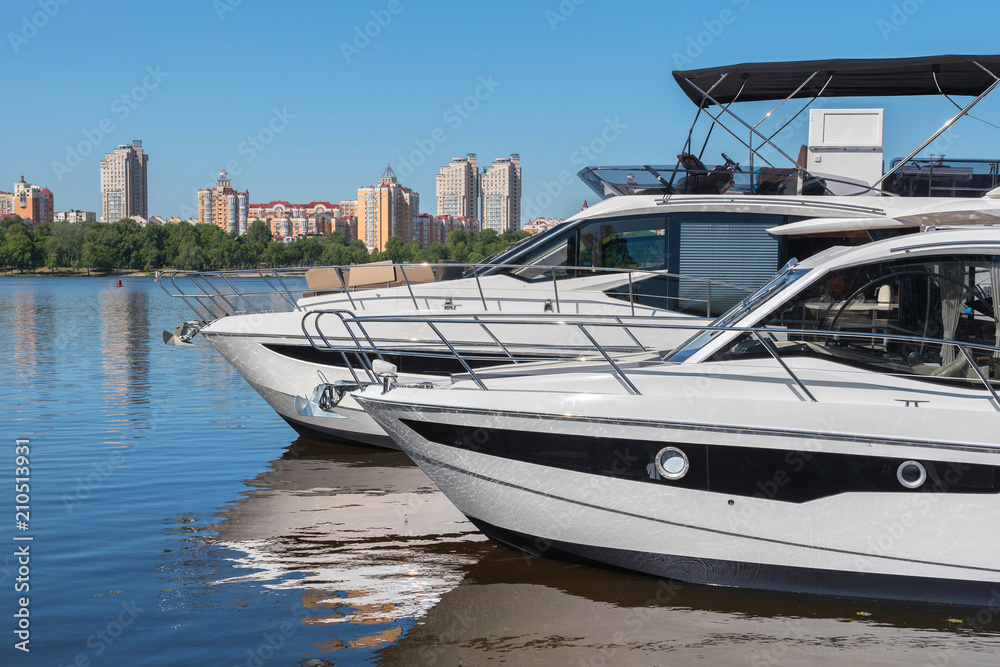 Fototapeta premium Kiev, Ukraine - June 01, 2018 : A marina, a pool with a dock with moorings and supplies for yachts and small boats, against the backdrop of the city