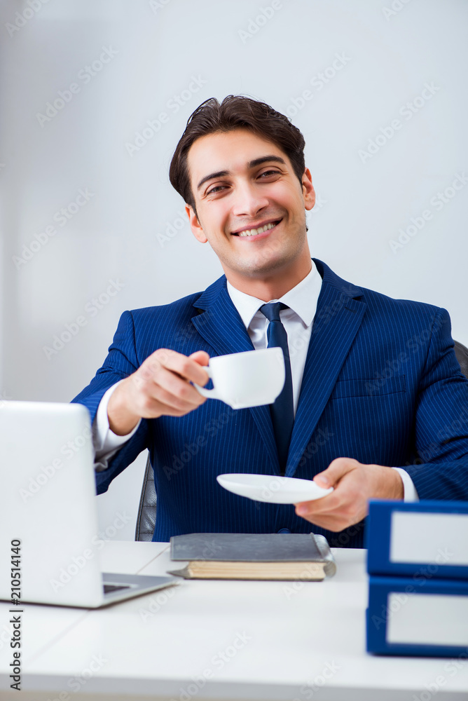 Young handsome businessman employee working in office at desk Young handsome businessman employee working in office at desk