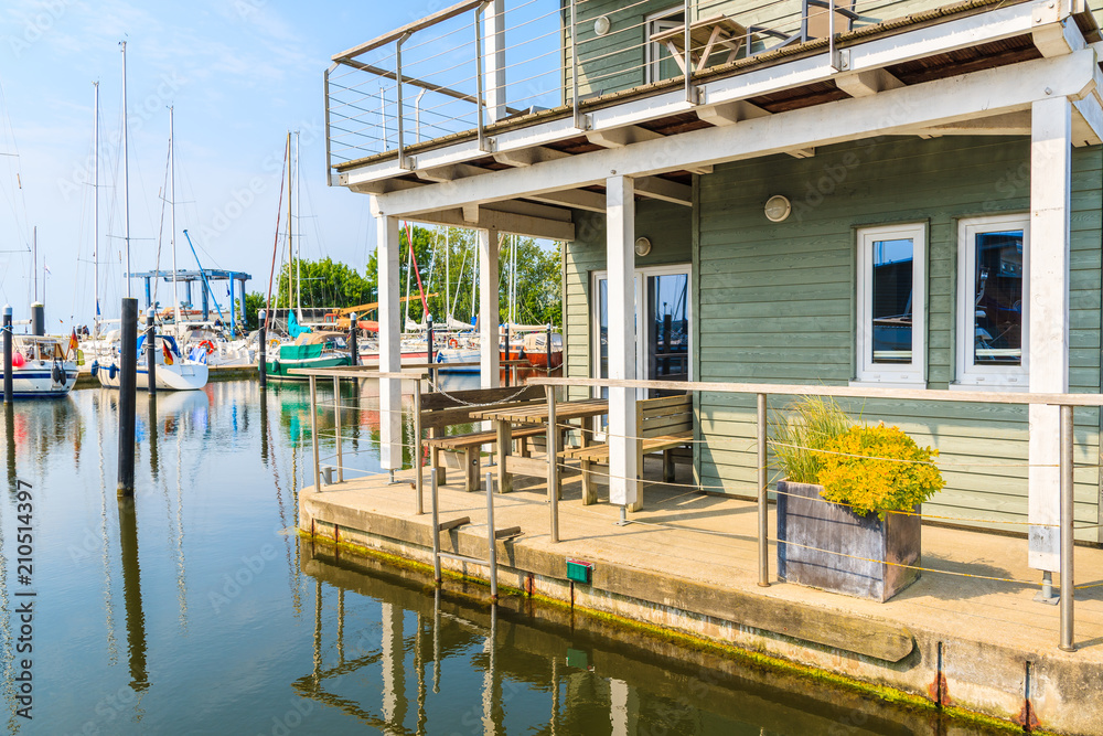 Obraz premium Holiday house terrace on water in Lauterbach port, Ruegen island, Baltic Sea, Germany