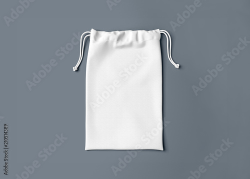 White drawstring bag on background. Fabric cotton small bag. Isolated pouch. photo