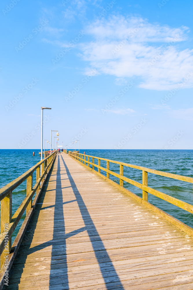 Pier in Goehren town with beautiful blue sea and sunny sky, Ruegen island, Baltic Sea, Germany