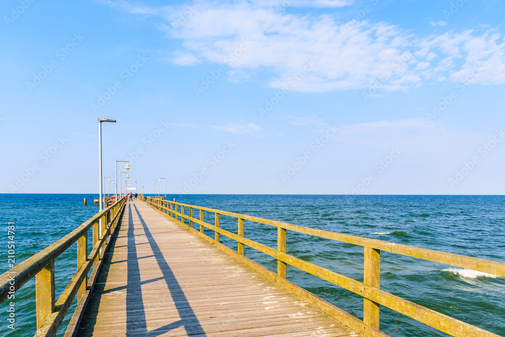 Pier in Goehren summer resort with beautiful blue sea and sunny sky, Ruegen island, Baltic Sea, Germany