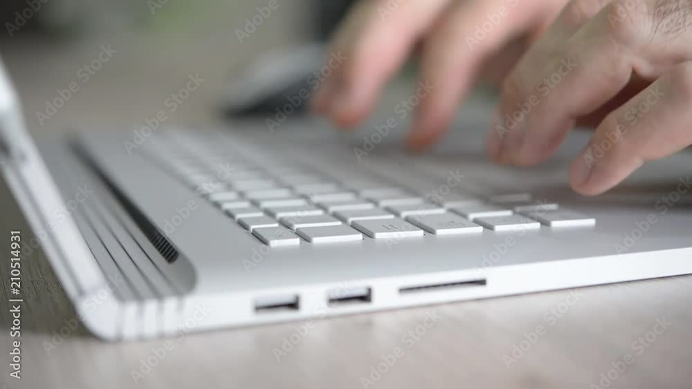 Closeup of hands working and typing on laptop keyboard on table Closeup of hands working and typing on laptop keyboard on table
