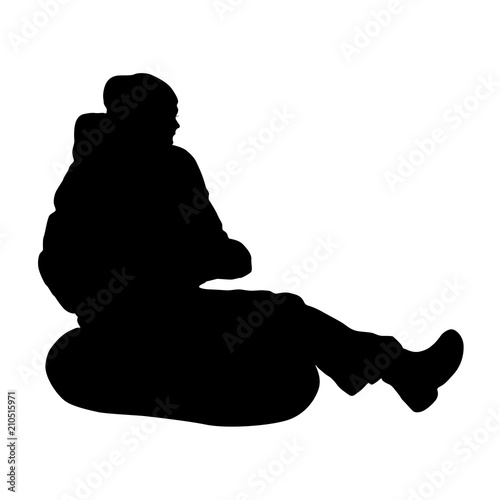 Silhouette of man and having fun inflatable rubber tube sled on white background