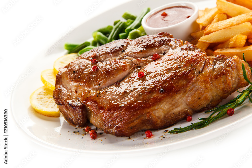 Grilled steak, French fries and vegetables Grilled steak, French fries and vegetables