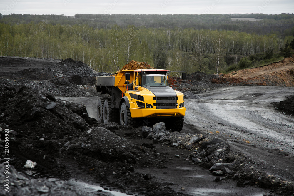 Articulated dump truck on the road in an open coal mine.