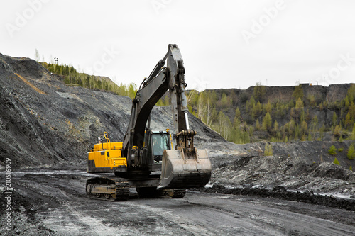 Excavator in an open coal mine. Heavy industry.