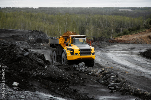 Articulated dump truck on the road in an open coal mine.