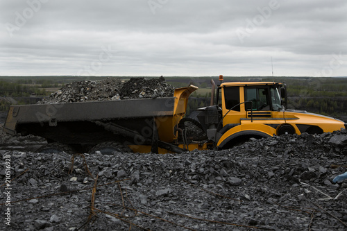 Articulated dump truck on the road in an open coal mine.