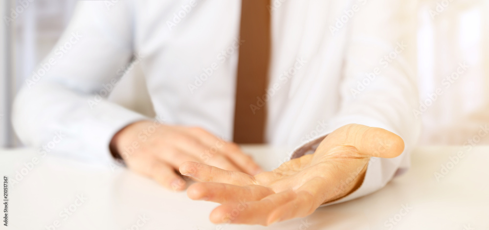 Empty holding hands of a  businessman over a desk