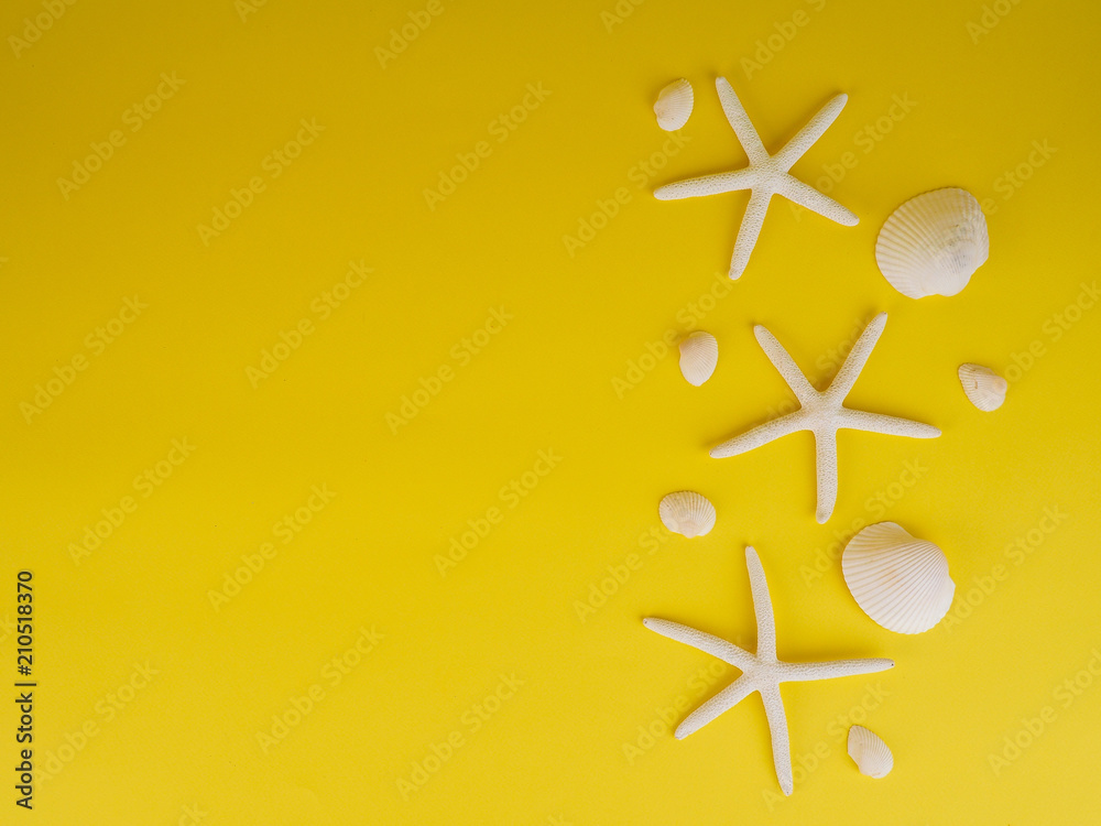 Tropical Background with starfish on yellow background. flat lay, top view Tropical Background with starfish on yellow background. flat lay, top view