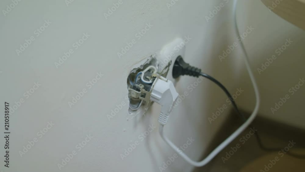 The cable is plugged into a broken electrical outlet