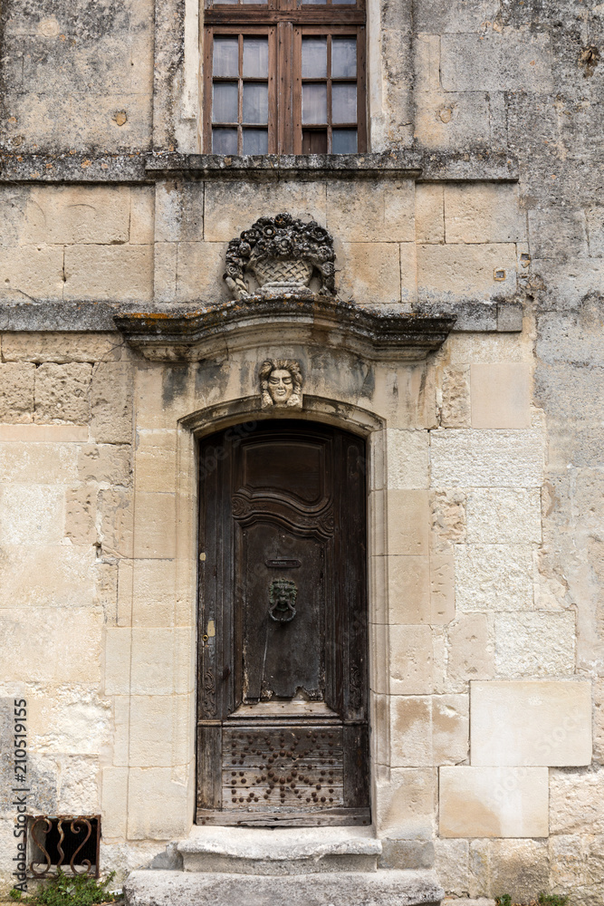 Old wooden door on stone  house  in Les Baux de Provence, France